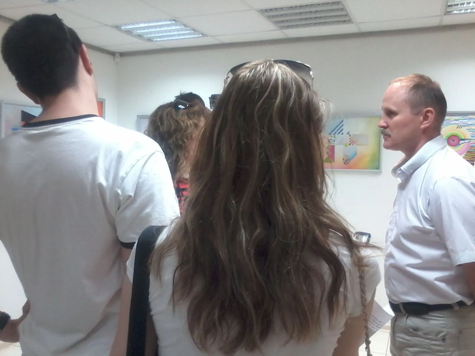 Visitors gathered around the artist at the opening of his exhibition